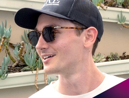 Portrait Greg Del Vecho smiling outdoors with a CIRE baseball cap on