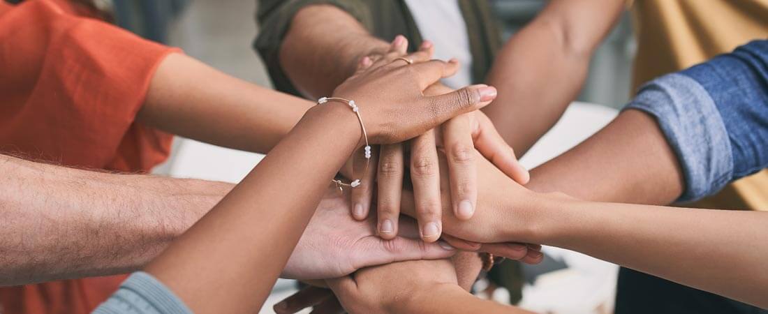 Shot of a unrecognizable team of business people stacking their hands in motivation